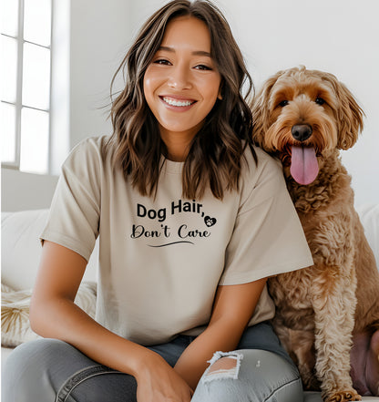 A person wearing a natural T-shirt with the playful black text “Dog Hair, Don’t Care” and a paw print accent. The design embraces the humor and love of dog ownership, making it a perfect casual fashion statement for pet lovers who proudly accept furry companionship.