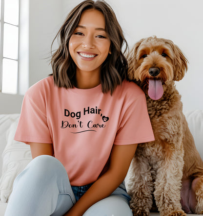 A person wearing a sunset T-shirt with the playful black text “Dog Hair, Don’t Care” and a paw print accent. The design embraces the humor and love of dog ownership, making it a perfect casual fashion statement for pet lovers who proudly accept furry companionship.