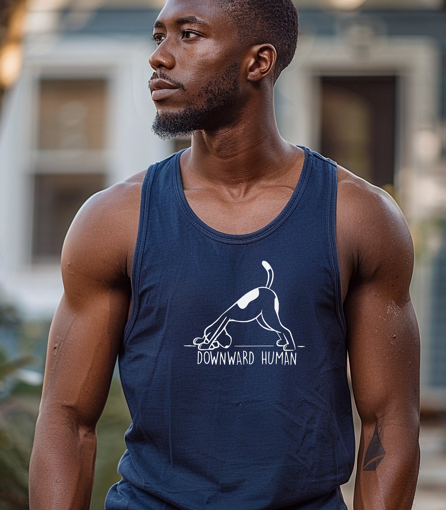 Downward Human tank top featuring a playful design of a dog doing a yoga pose, mimicking the popular downward dog position. The humorous graphic includes the text 'Downward Human,' making it perfect for dog lovers and yoga enthusiasts. Printed on a soft, lightweight navy tank, this fun and casual design blends fitness and pet humor, ideal for workouts, lounging, or outdoor activities.