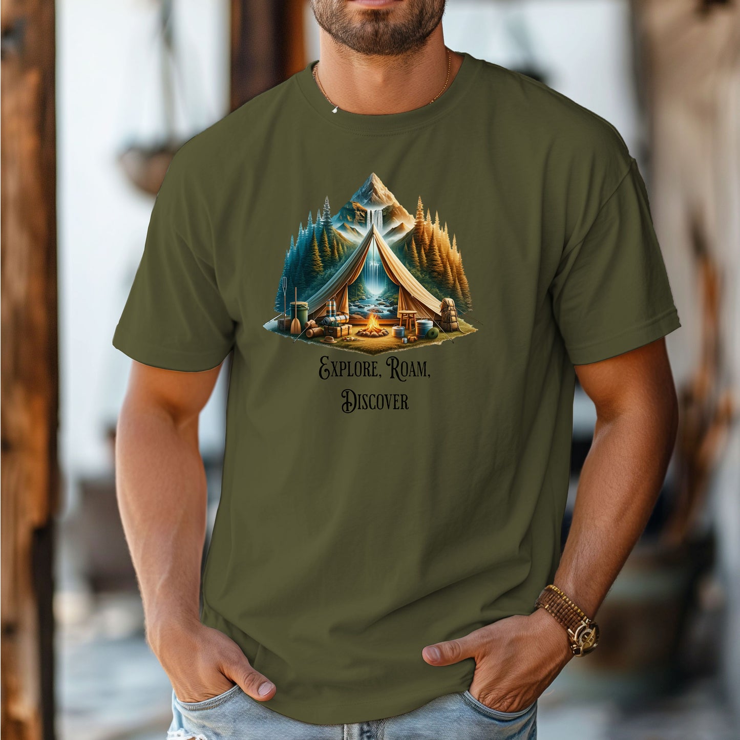 Hemp color “Explore, Roam, Discover” T-shirt featuring a scenic camping design with an open tent framing a mountain, waterfall, pine forest, and river. A cozy campfire, gear, and canoe paddles sit in the foreground, creating an adventurous and tranquil outdoor vibe. Perfect for nature lovers, hikers, and camping enthusiasts seeking wanderlust-inspired apparel.