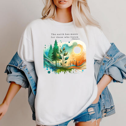 Classic White T-shirt featuring a vibrant “Earth Music” nature design with the quote “The earth has music for those who listen – Shakespeare.” Artwork showcases a sunrise over green pine trees, flowing waves, and a sprouting plant, blending watercolor textures with bright greens, blues, and oranges.  This eco-inspired graphic tee celebrates the beauty and harmony of nature.