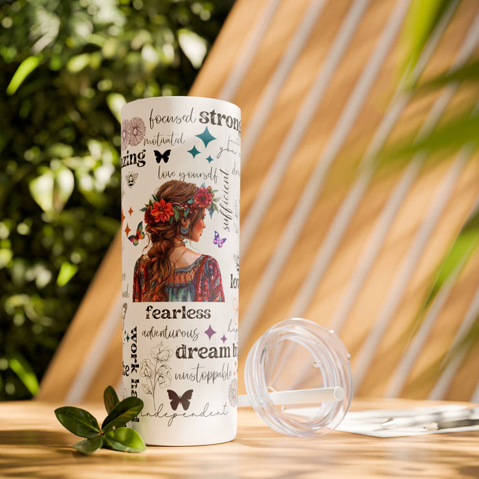 Empowering Motivational Skinny Tumbler – 20 oz featuring an artistic design with a woman adorned in a floral crown on the back and surrounded by uplifting words like strong, fearless, confident, love, believe, and inspirational. Accented with butterflies, bees, and flowers, this reusable stainless steel tumbler is perfect for keeping drinks hot or cold while inspiring positivity and self-confidence every day.