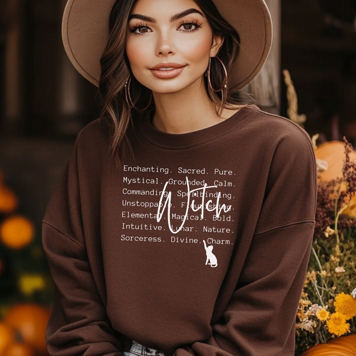 Person wearing a Dark Chocolate sweatshirt with text and a cat graphic, standing outdoors with blurred background