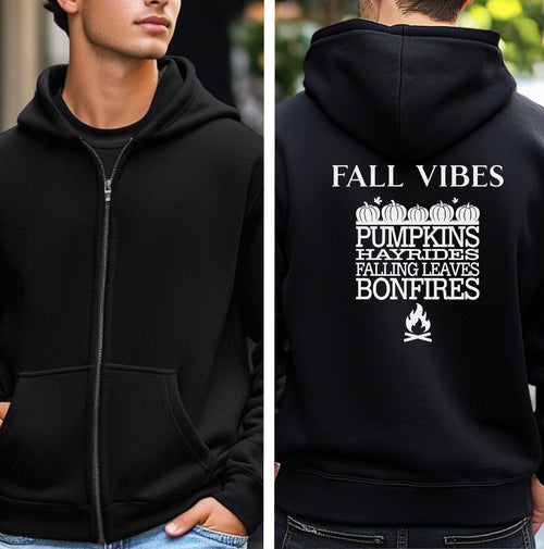 Black Gildan hoodie featuring a white “FALL VIBES” design on the back with stacked seasonal words: “PUMPKINS, HAYRIDES, FALLING LEAVES, BONFIRES,” framed by pumpkins above and a bonfire icon below. A cozy, festive graphic perfect for autumn lovers and fall adventures.