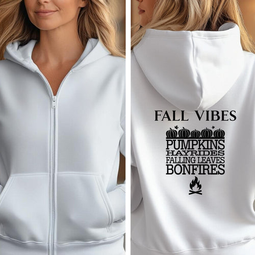 White Gildan hoodie featuring a black “FALL VIBES” design on the back with stacked seasonal words: “PUMPKINS, HAYRIDES, FALLING LEAVES, BONFIRES,” framed by pumpkins above and a bonfire icon below. A cozy, festive graphic perfect for autumn lovers and fall adventures.