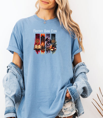 Fantasy-themed t-shirt design featuring four vertical panels with vibrant mystical elements: open spellbooks, candles, magical symbols, ancient tomes, a fierce dragon, and a steaming cup of coffee. Rich tones of red, orange, purple, and blue create an enchanting atmosphere—perfect for fantasy book lovers, magic fans, and mystical minds.