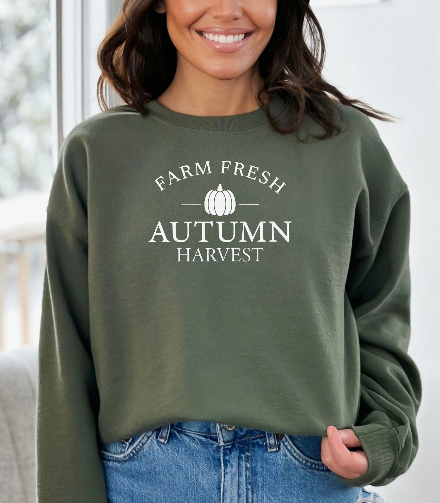 Military Green Gildan sweatshirt featuring a minimalist white Farm Fresh Autumn Harvest design with a simple pumpkin graphic in the center. A clean and classic fall look that captures rustic charm and seasonal spirit—perfect for farmers markets, pumpkin patches, and cozy autumn days.