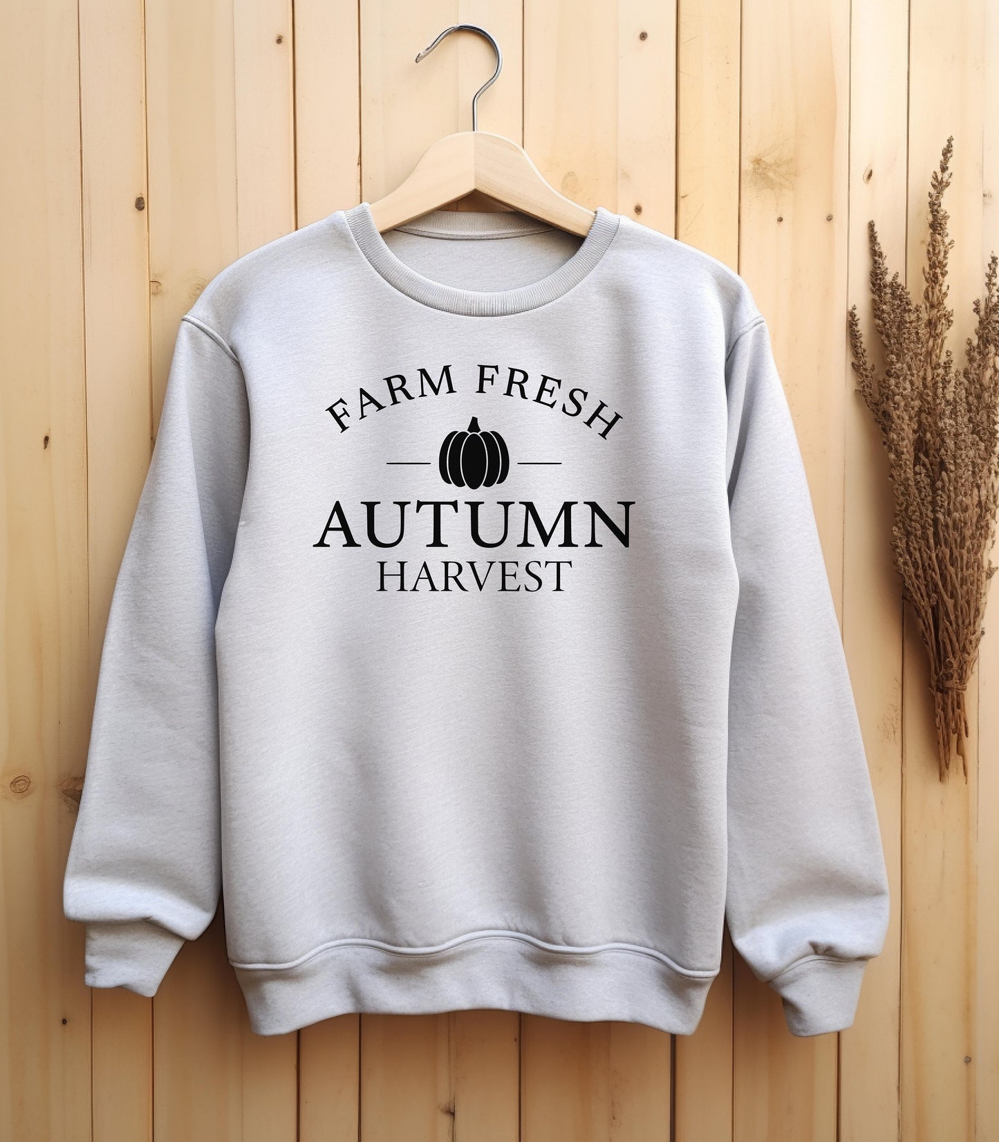 Ash Gildan sweatshirt featuring a minimalist black Farm Fresh Autumn Harvest” design with a simple pumpkin graphic in the center. A clean and classic fall look that captures rustic charm and seasonal spirit—perfect for farmers markets, pumpkin patches, and cozy autumn days.