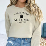 Sand Gildan sweatshirt featuring a minimalist black “Farm Fresh Autumn Harvest” design with a simple pumpkin graphic in the center. A clean and classic fall look that captures rustic charm and seasonal spirit—perfect for farmers' markets, pumpkin patches, and cozy autumn days.