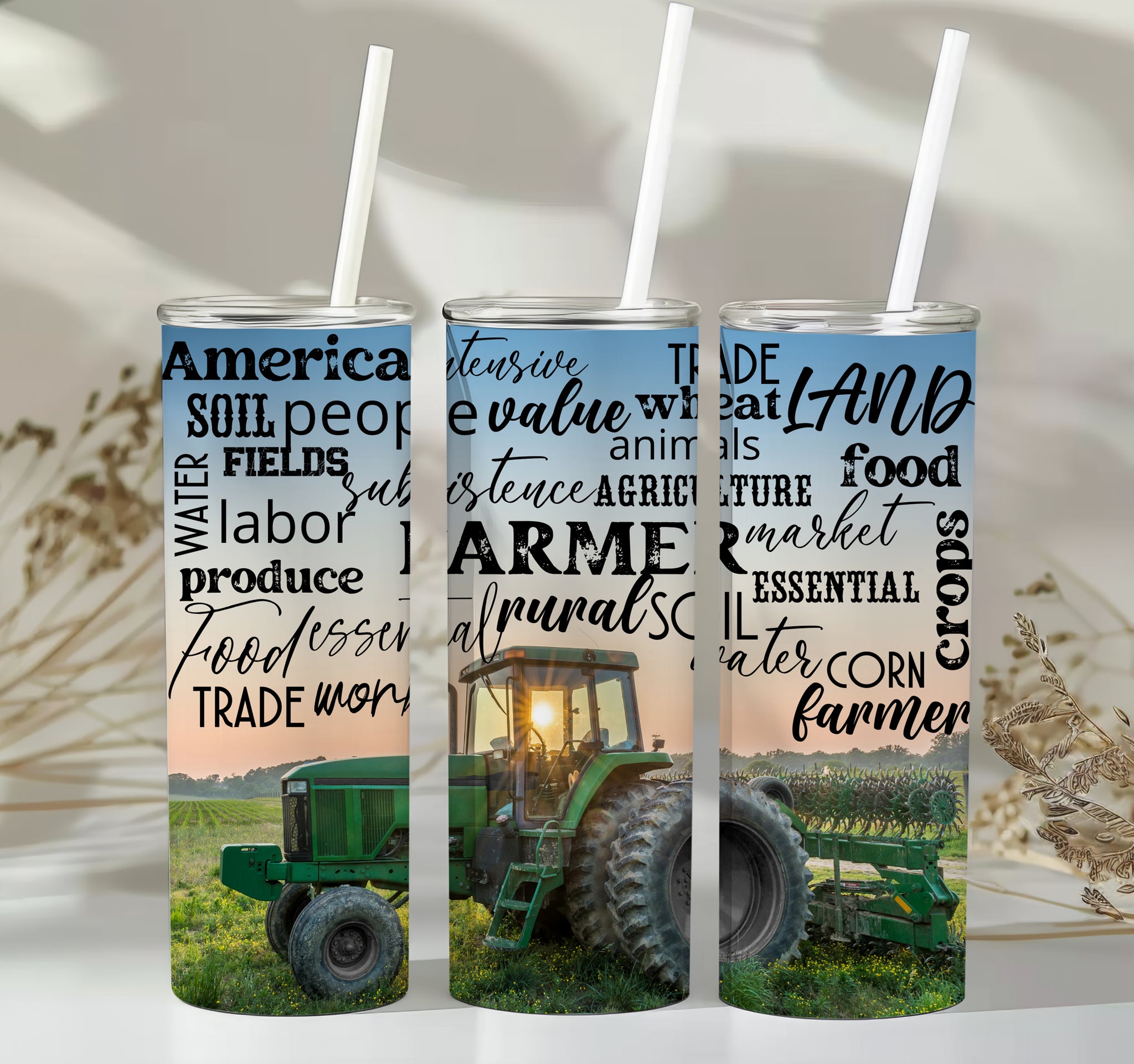 Farm Life Skinny Tumbler – 20 oz featuring a rustic farm scene with a green tractor in a field at sunrise and a background of farming-related words like soil, crops, harvest, land, produce, and hard work. This durable stainless steel tumbler celebrates the farming lifestyle and rural heritage, perfect for keeping drinks hot or cold while honoring agriculture and those who work the land.