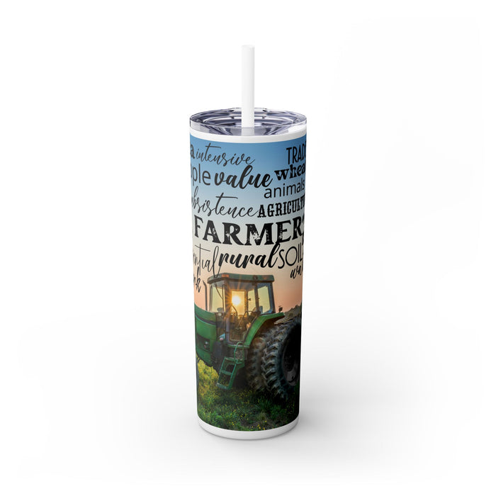 Farm Life Skinny Tumbler – 20 oz featuring a rustic farm scene with a green tractor in a field at sunrise and a background of farming-related words like soil, crops, harvest, land, produce, and hard work. This durable stainless steel tumbler celebrates the farming lifestyle and rural heritage, perfect for keeping drinks hot or cold while honoring agriculture and those who work the land.