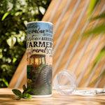 Farm Life Skinny Tumbler – 20 oz featuring a rustic farm scene with a green tractor in a field at sunrise and a background of farming-related words like soil, crops, harvest, land, produce, and hard work. This durable stainless steel tumbler celebrates the farming lifestyle and rural heritage, perfect for keeping drinks hot or cold while honoring agriculture and those who work the land.