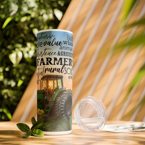 Farm Life Skinny Tumbler – 20 oz featuring a rustic farm scene with a green tractor in a field at sunrise and a background of farming-related words like soil, crops, harvest, land, produce, and hard work. This durable stainless steel tumbler celebrates the farming lifestyle and rural heritage, perfect for keeping drinks hot or cold while honoring agriculture and those who work the land.
