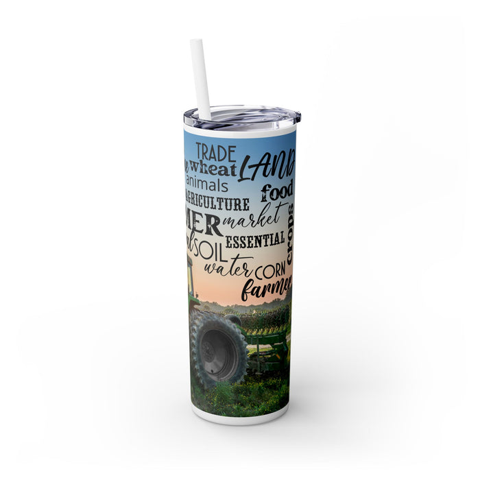 Farm Life Skinny Tumbler – 20 oz featuring a rustic farm scene with a green tractor in a field at sunrise and a background of farming-related words like soil, crops, harvest, land, produce, and hard work. This durable stainless steel tumbler celebrates the farming lifestyle and rural heritage, perfect for keeping drinks hot or cold while honoring agriculture and those who work the land.