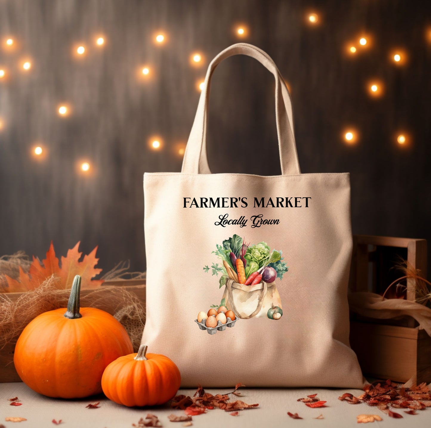Tote bag with 'Farmer's Market Locally Grown' text and vegetable illustration, surrounded by pumpkins and autumn leaves.