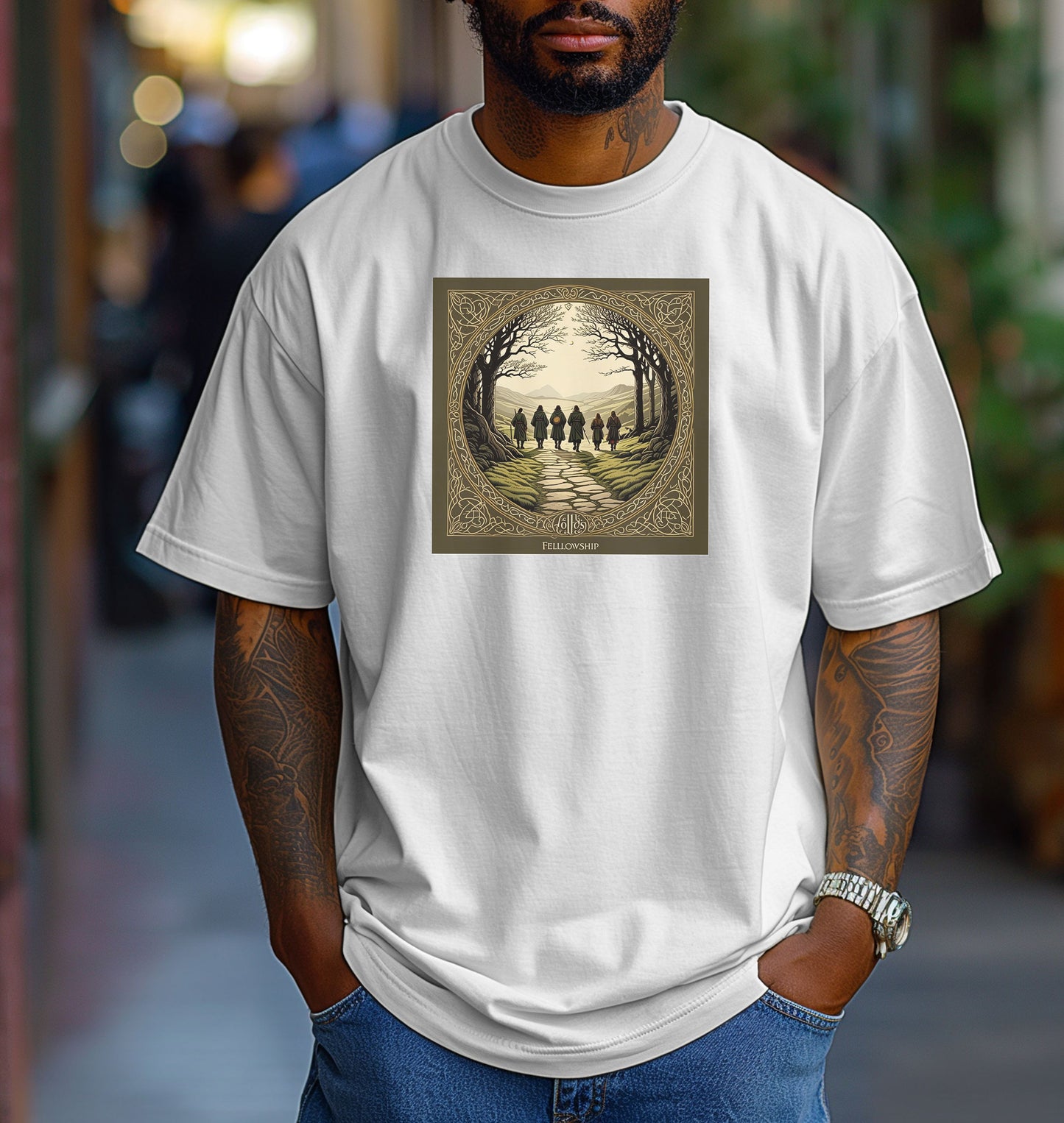 Classic White “Fellowship” T-shirt featuring a fantasy-inspired design of five cloaked figures walking along a stone path toward distant mountains. The scene is framed by intricate Celtic-style borders with bare trees arching overhead, creating an adventurous and mythical atmosphere. Perfect for fans of epic journeys, fantasy worlds, and storytelling-inspired apparel.