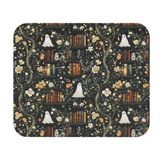Decorative mouse pad with ghosts, flowers, and books design on a black background