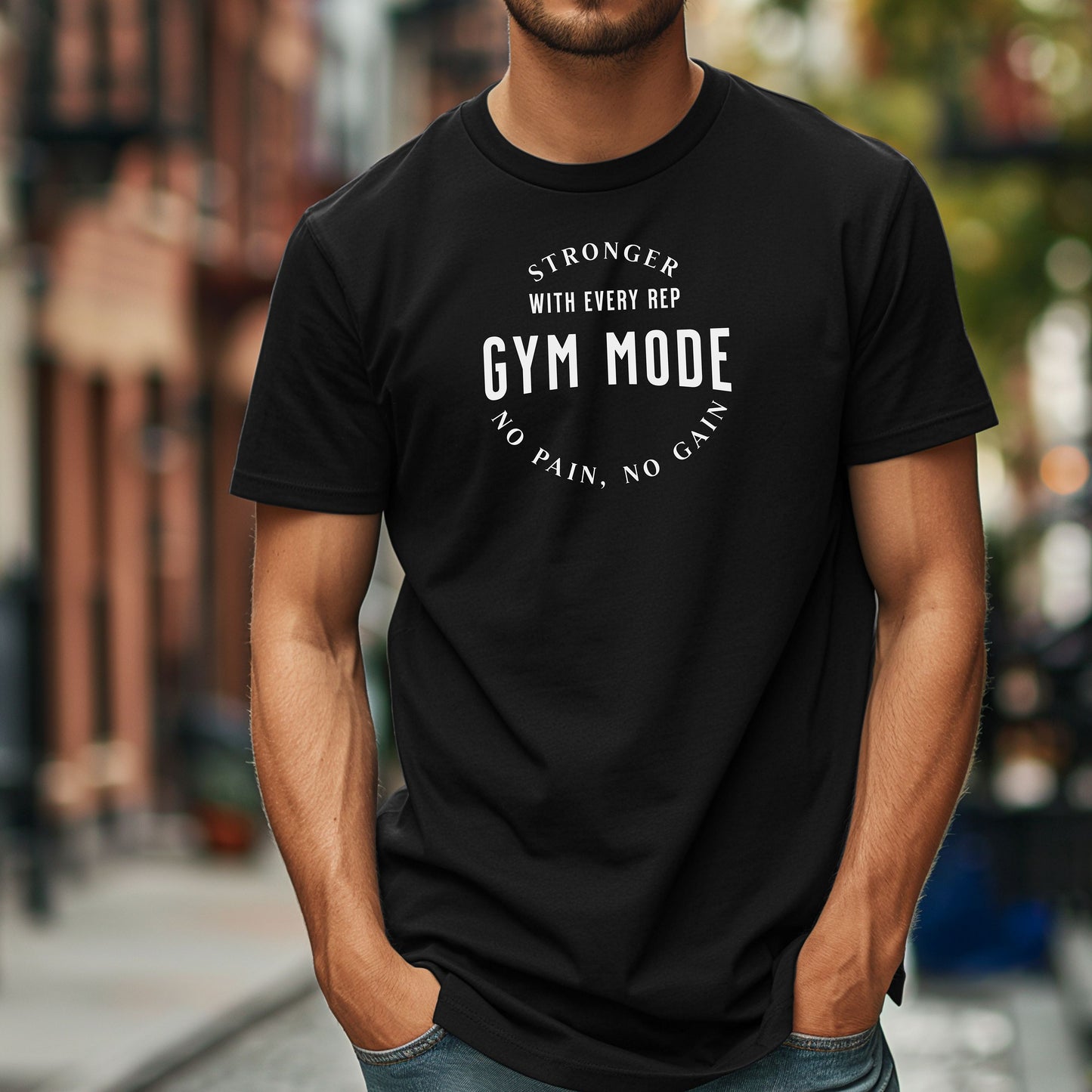A person wearing a  black T-shirt with the bold white text “Stronger With Every Rep – Gym Mode – No Pain, No Gain.” The fitness-themed design features a curved text layout, perfect for workout enthusiasts and gym-goers who embrace strength training and motivation.