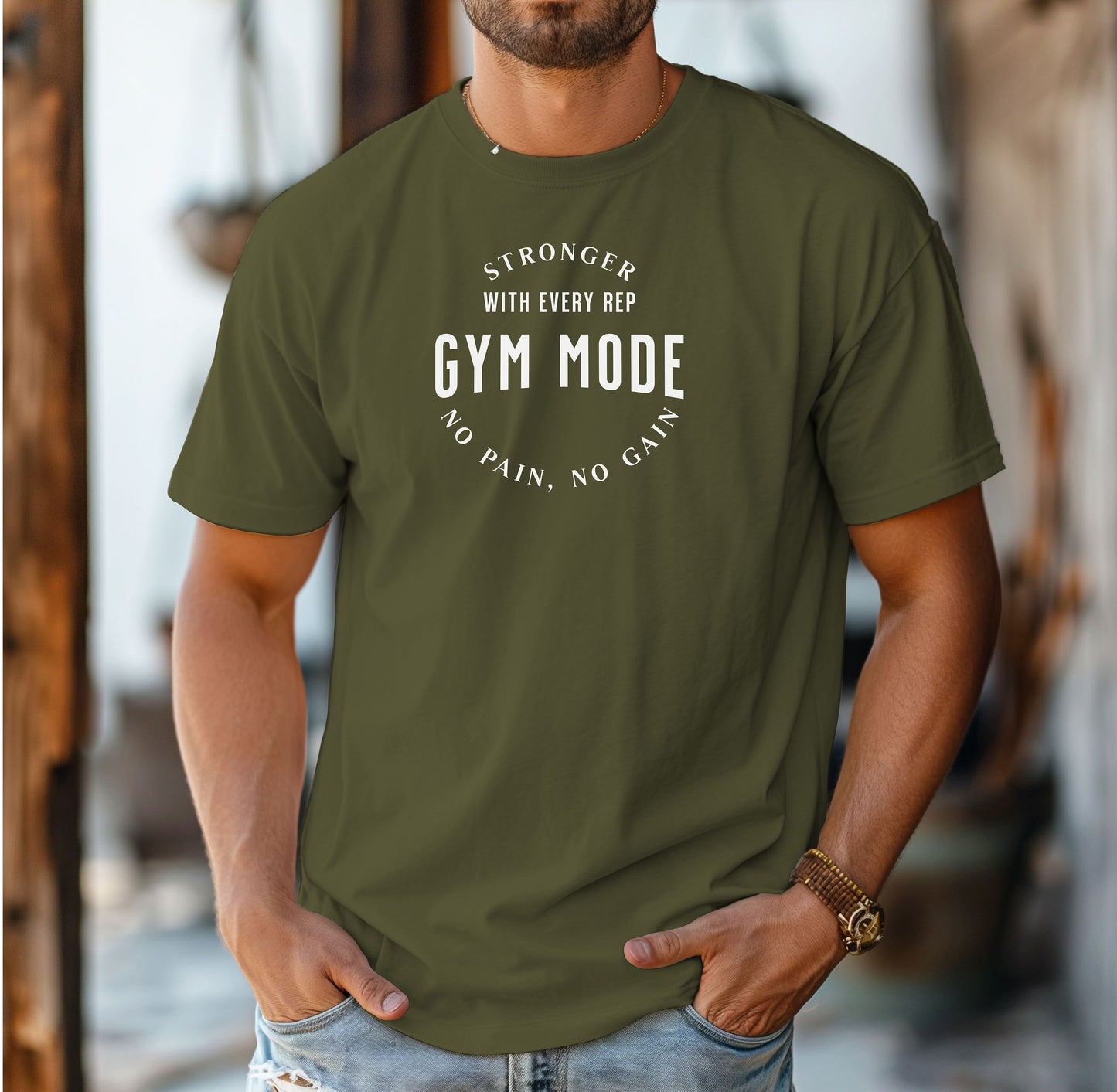 A person wearing a  hemp color T-shirt with the bold white text “Stronger With Every Rep – Gym Mode – No Pain, No Gain.” The fitness-themed design features a curved text layout, perfect for workout enthusiasts and gym-goers who embrace strength training and motivation.