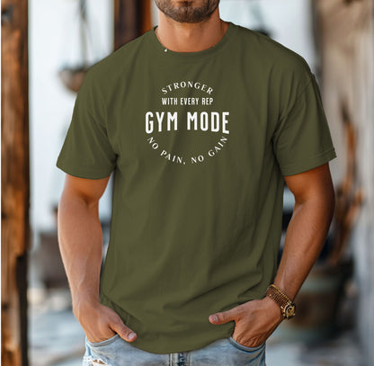 A person wearing a  hemp color T-shirt with the bold white text “Stronger With Every Rep – Gym Mode – No Pain, No Gain.” The fitness-themed design features a curved text layout, perfect for workout enthusiasts and gym-goers who embrace strength training and motivation.