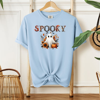 Chambray light blue T-shirt featuring a cute "Spooky" Halloween design with a smiling ghost surrounded by pumpkins, sunflowers, and autumn leaves. The word "Spooky" is styled with rustic wood-textured letters accented with fall foliage. Perfect for festive fall outfits, Halloween parties, or cozy seasonal wear.