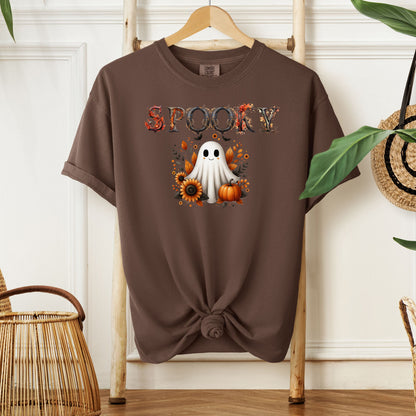 Espresso T-shirt featuring a cute "Spooky" Halloween design with a smiling ghost surrounded by pumpkins, sunflowers, and autumn leaves. The word "Spooky" is styled with rustic wood-textured letters accented with fall foliage. Perfect for festive fall outfits, Halloween parties, or cozy seasonal wear.