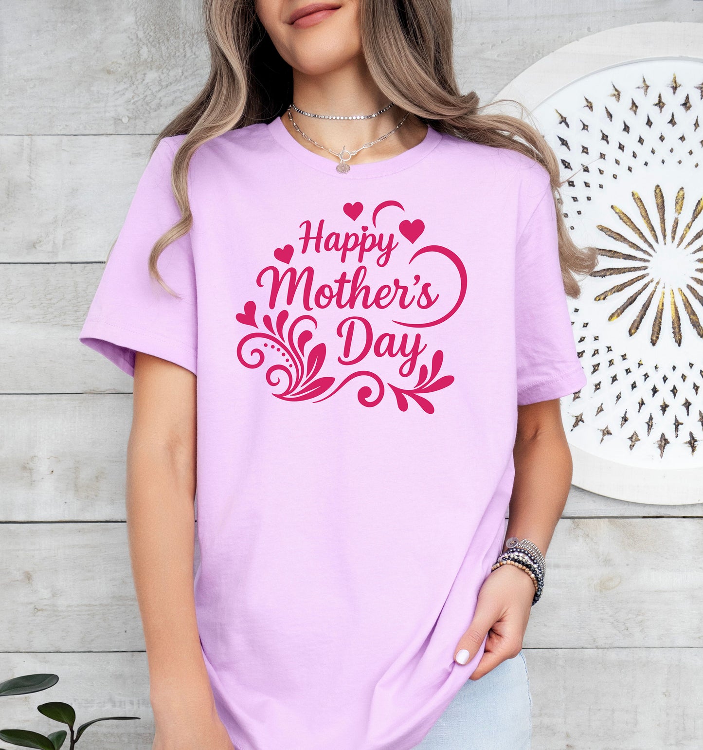 Person wearing a lilac 'Happy Mother's Day' t-shirt against a light wooden background