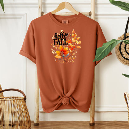 Yam T-shirt featuring a vibrant "Hello Fall" design with hand-painted autumn leaves in orange, yellow, and soft grey blue tones. The bold black lettering is accented by delicate foliage, giving this seasonal tee a cozy, cheerful, and nature-inspired look perfect for fall fashion.