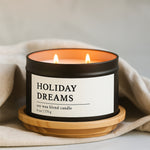 Holiday Dreams soy wax blend candle in a 8 oz black matte candle tin on a wooden coaster with a beige cloth background