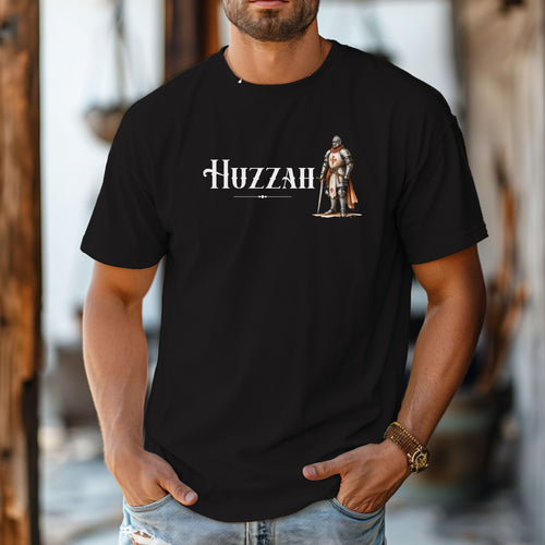 Black T-shirt featuring a Renaissance Faire design with the word “Huzzah” in medieval-style lettering and an illustration of a knight in shining armor. Perfect for Renaissance fair goers, medieval enthusiasts, and fans of historical festivals, celebrating the lively and spirited call of “Huzzah” at fairs and events.