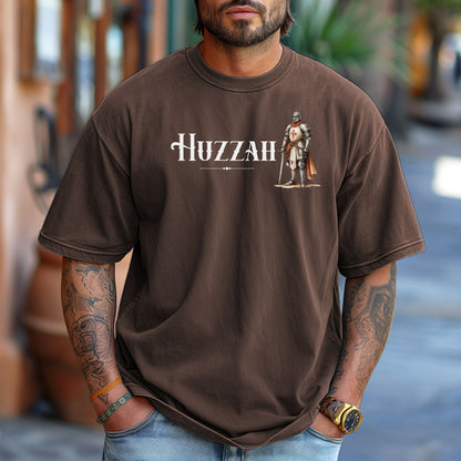 Espresso T-shirt featuring a Renaissance Faire design with the word “Huzzah” in medieval-style lettering and an illustration of a knight in shining armor. Perfect for Renaissance fair goers, medieval enthusiasts, and fans of historical festivals, celebrating the lively and spirited call of “Huzzah” at fairs and events.

