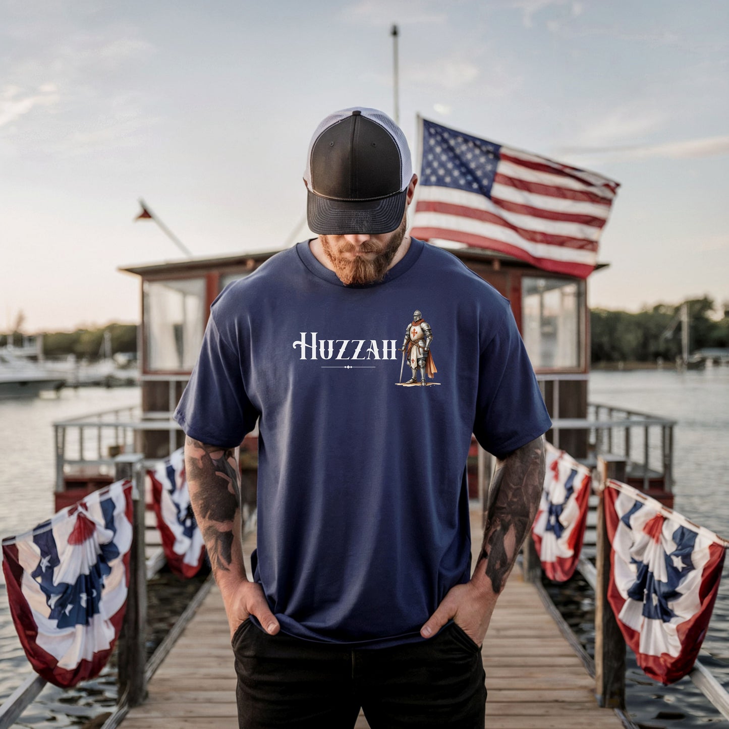 True Navy T-shirt featuring a Renaissance Faire design with the word “Huzzah” in medieval-style lettering and an illustration of a knight in shining armor. Perfect for Renaissance fair goers, medieval enthusiasts, and fans of historical festivals, celebrating the lively and spirited call of “Huzzah” at fairs and events.
