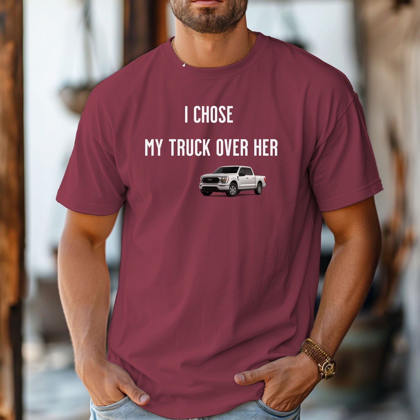 Chili T-shirt featuring the bold black text "I Chose My Truck Over Her" with a graphic of a white pickup truck beneath the words. The design has a humorous, confident tone, appealing to truck lovers and automotive enthusiasts. 