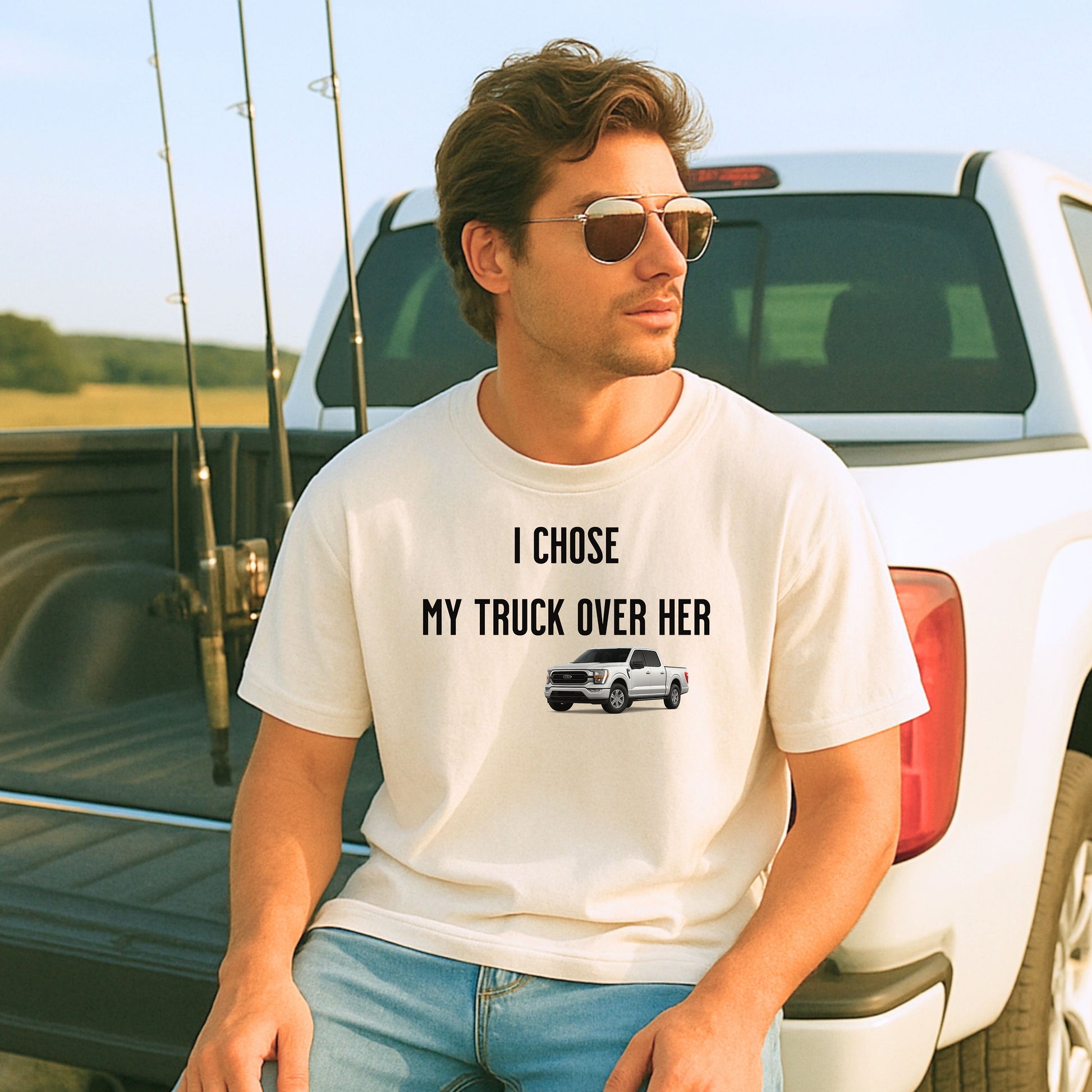 Ivory T-shirt featuring the bold black text "I Chose My Truck Over Her" with a graphic of a white pickup truck beneath the words. The design has a humorous, confident tone, appealing to truck lovers and automotive enthusiasts. 