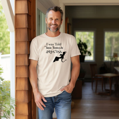 Person wearing an Ivory T-shirt with a Renaissance Faire-inspired design that reads “I Was Told There Would Be Dragons” in medieval-style fonts. The graphic features a bold silhouette of a flying dragon, perfect for fantasy lovers and fairgoers who enjoy whimsical and mythical-themed apparel.