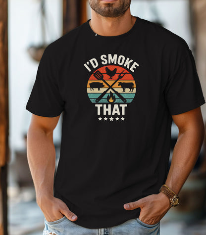 I’d Smoke That T-shirt featuring a retro sunset-style circle graphic with silhouettes of a chicken, pig, and cow, crossed grilling utensils, and a small flame. Text appears above and below the design, accented by five stars at the bottom. Printed on a black unisex tee, this fun BBQ-themed shirt is perfect for grill masters, smoking enthusiasts, and meat lovers who enjoy cooking with humor.