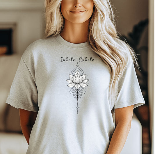 Person wearing an ash T-shirt featuring an elegant black line art lotus flower design with decorative flourishes, topped by the words “Inhale, Exhale” in a graceful script font. The minimalist, zen-inspired artwork conveys peace, mindfulness, and calm, making it perfect for yoga lovers, meditation enthusiasts, and those who embrace a serene, balanced lifestyle.
