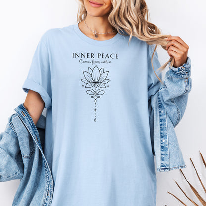 Person wearing a Chambray light blue T-shirt featuring an “Inner Peace Comes from Within” design with a black line art lotus flower and elegant ornamental accents. The minimalist, symmetrical artwork conveys tranquility, mindfulness, and spiritual balance, making it perfect for yoga enthusiasts, meditation lovers, and those seeking calm, positive energy in their everyday style.