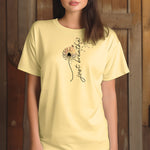 Just Breathe T-shirt featuring an artistic dandelion design with seeds blowing in the wind, transitioning into the handwritten phrase 'just breathe.' Printed on a soft, pastel banana unisex tee, this calming and inspirational graphic is perfect for promoting mindfulness, relaxation, and a peaceful mindset. Ideal for yoga lovers, nature enthusiasts, and casual everyday wear.