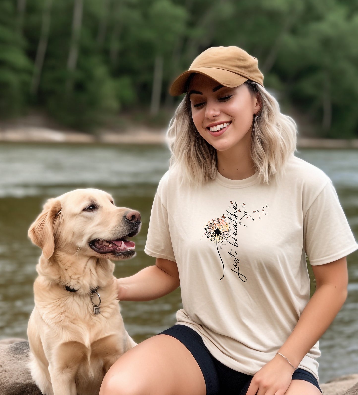 Just Breathe T-shirt featuring an artistic dandelion design with seeds blowing in the wind, transitioning into the handwritten phrase 'just breathe.' Printed on an ivory unisex tee, this calming and inspirational graphic is perfect for promoting mindfulness, relaxation, and a peaceful mindset. Ideal for yoga lovers, nature enthusiasts, and casual everyday wear.