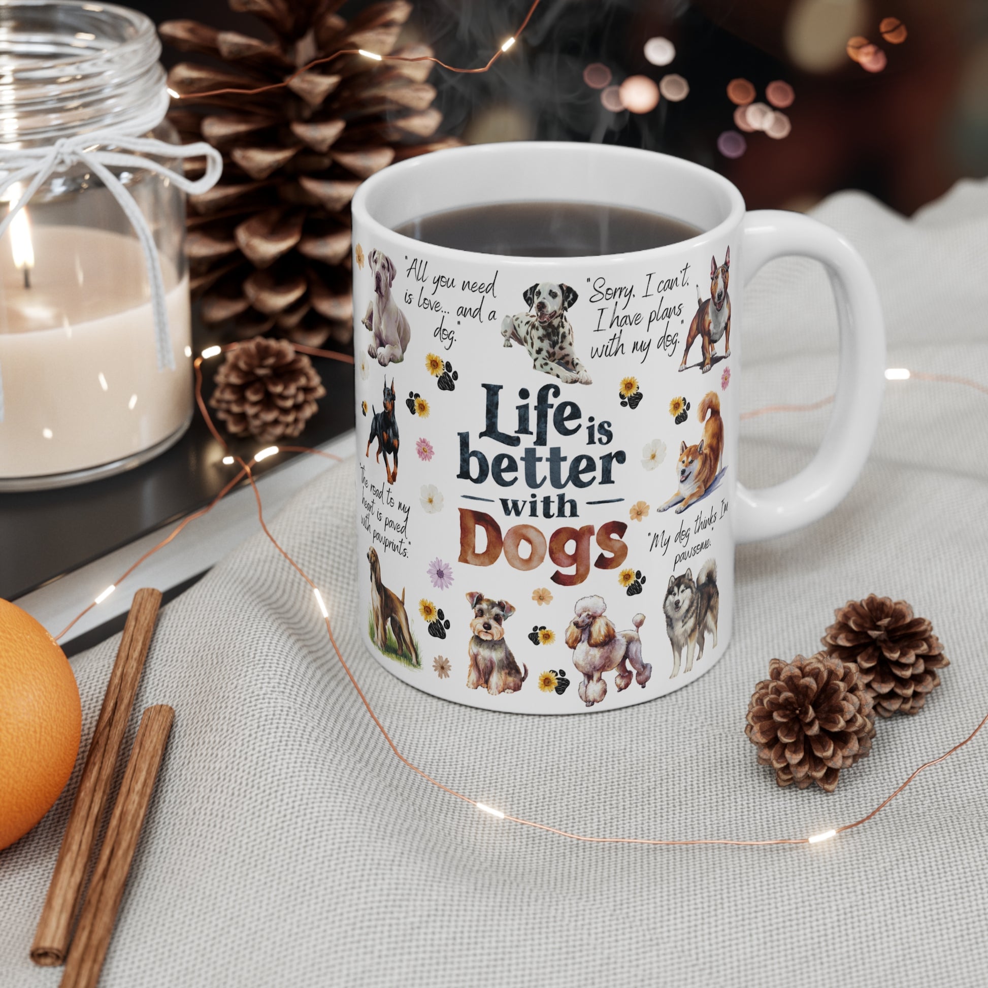 Ceramic Mug with dog-themed design and 'Life is better with dogs' text, surrounded by decorative items on a table.