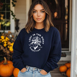 Navy sweatshirt featuring a white graphic design of a mountain range with a compass rising behind it, surrounded by pine trees. The words "Lost In The Right Direction" curve around the design, blending adventure and wanderlust vibes. Perfect for outdoor enthusiasts, hikers, and travelers seeking inspiration and style in casual wear.