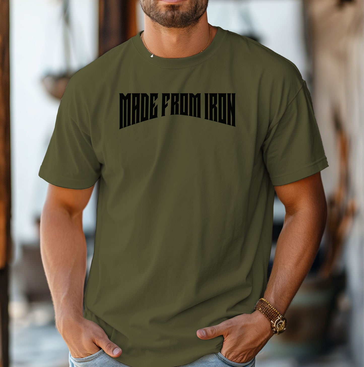 Person wearing a hemp color T-shirt featuring the bold text “MADE FROM IRON” in a strong, arched black font across the chest. The design conveys strength, resilience, and determination, making it perfect for fitness enthusiasts, bodybuilders, and athletes who embrace a powerful mindset. Casual streetwear style with a rugged, motivational vibe ideal for workouts, training, or everyday wear.