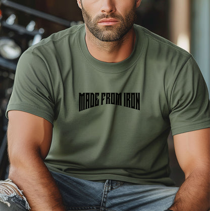 Person wearing a moss T-shirt featuring the bold text “MADE FROM IRON” in a strong, arched black font across the chest. The design conveys strength, resilience, and determination, making it perfect for fitness enthusiasts, bodybuilders, and athletes who embrace a powerful mindset. Casual streetwear style with a rugged, motivational vibe ideal for workouts, training, or everyday wear.