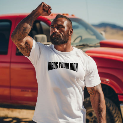 Person wearing a classic white T-shirt featuring the bold text “MADE FROM IRON” in a strong, arched black font across the chest. The design conveys strength, resilience, and determination, making it perfect for fitness enthusiasts, bodybuilders, and athletes who embrace a powerful mindset. Casual streetwear style with a rugged, motivational vibe ideal for workouts, training, or everyday wear.