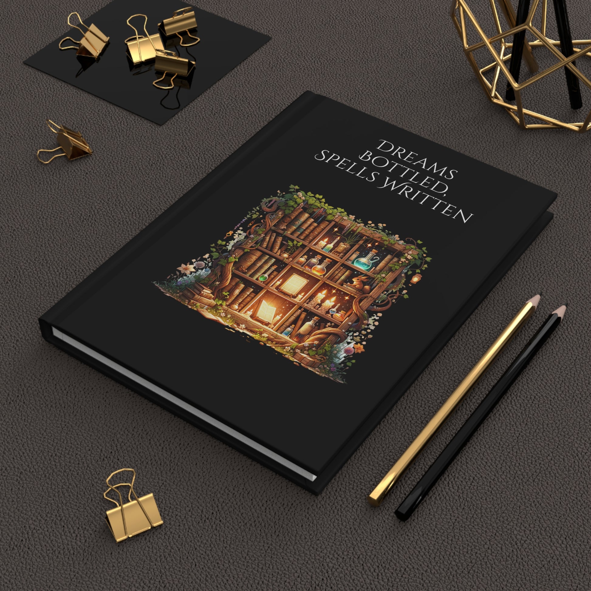 Hardcover journal with a wooden bookcase illustration and text on a dark surface with stationery items.