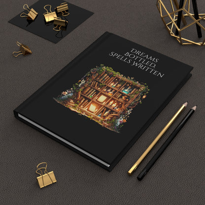 Hardcover journal with a wooden bookcase illustration and text on a dark surface with stationery items.
