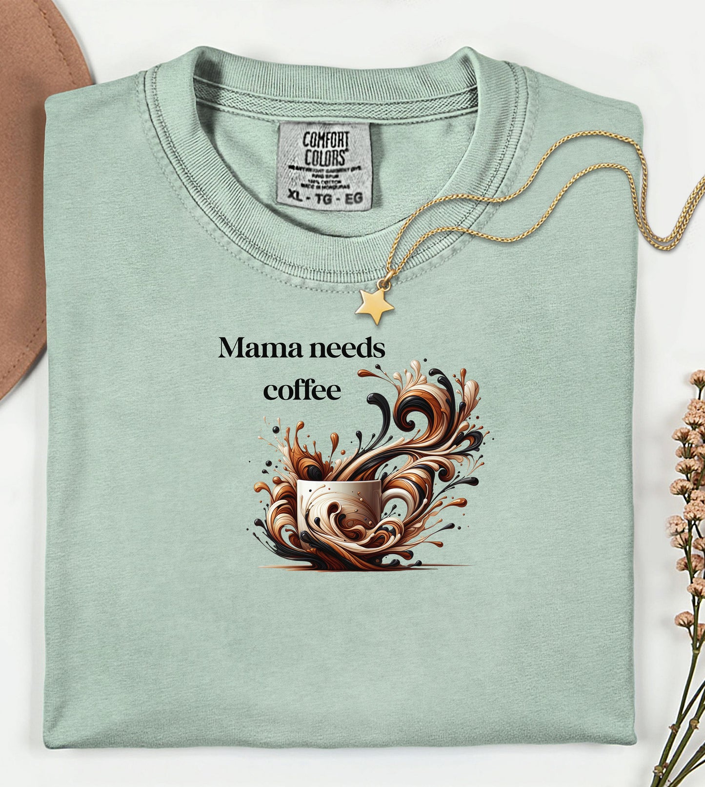 Artistic bay t-shirt design featuring a white coffee cup surrounded by dynamic swirls of coffee, cream, and espresso in rich browns and blacks. Bold and expressive "Mama needs coffee" text, this design captures the energy and chaos of caffeine cravings—perfect for moms who run on coffee and need a stylish way to show it.