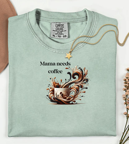 Artistic bay t-shirt design featuring a white coffee cup surrounded by dynamic swirls of coffee, cream, and espresso in rich browns and blacks. Bold and expressive "Mama needs coffee" text, this design captures the energy and chaos of caffeine cravings—perfect for moms who run on coffee and need a stylish way to show it.