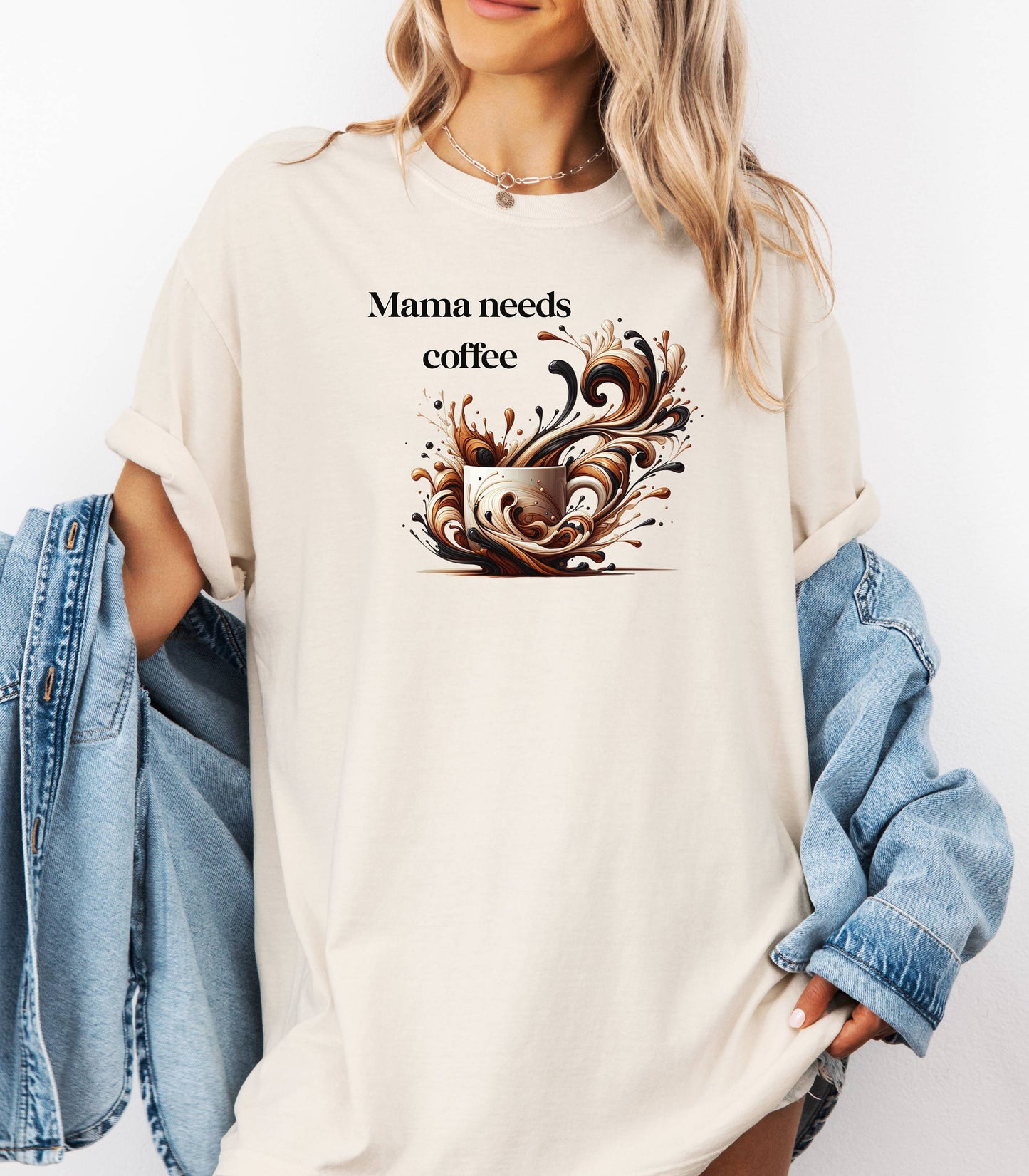Artistic Ivory t-shirt design featuring a white coffee cup surrounded by dynamic swirls of coffee, cream, and espresso in rich browns and blacks. Bold and expressive "Mama needs coffee" text this design captures the energy and chaos of caffeine cravings—perfect for moms who run on coffee and need a stylish way to show it.